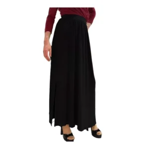 A model shown from the waist down wearing a long, black maxi skirt. She is wearing a burgundy long-sleeve top and open toe sandals.