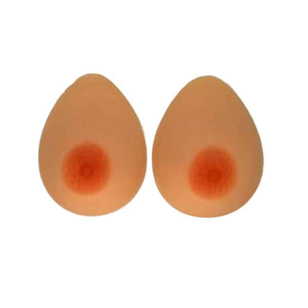 A pair of silicone breast forms, light flesh colored with realistic nipples.